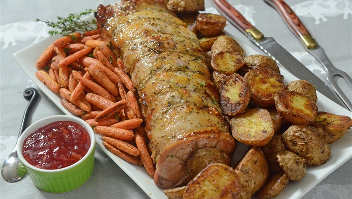 A rotisserie roasted pork loin with roasted carrots and potatoes makes for a meal worthy of a special occasion or special guests.